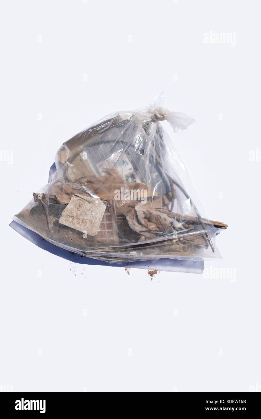 Clear bag of trash on solid white backdrop Stock Photo
