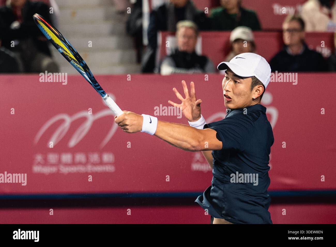 HONG KONG, China - JANUARY 09: Juncheng Shang of China hits the ball ...