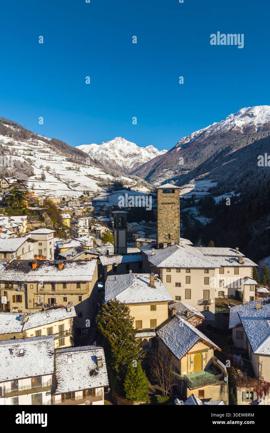 The village of Gromo with Pizzo Redorta after a snowfall in winter. Gromo, Val Seriana, Bergamo province, Lombardy, Italy, Europe. Stock Photo
