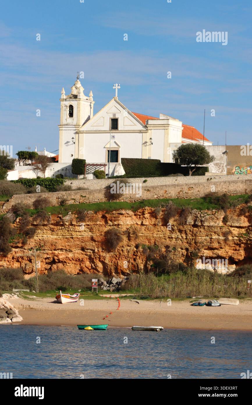 Igreja de Nossa Senhora da Conceição (Ferragudo), Ferragudo, seen from the River Arade, near Portimao, Algarve, Portugal Stock Photo
