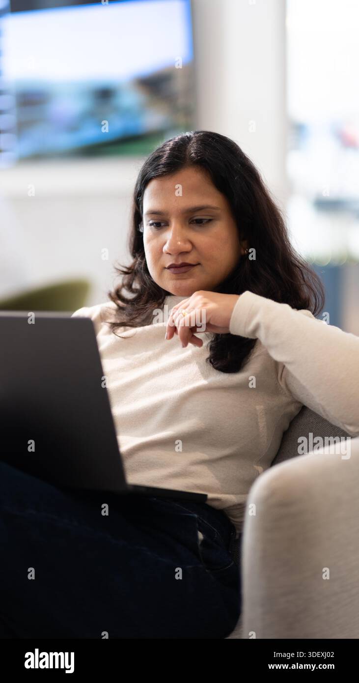 freelancer working remotely on laptop from a cafe Stock Photo