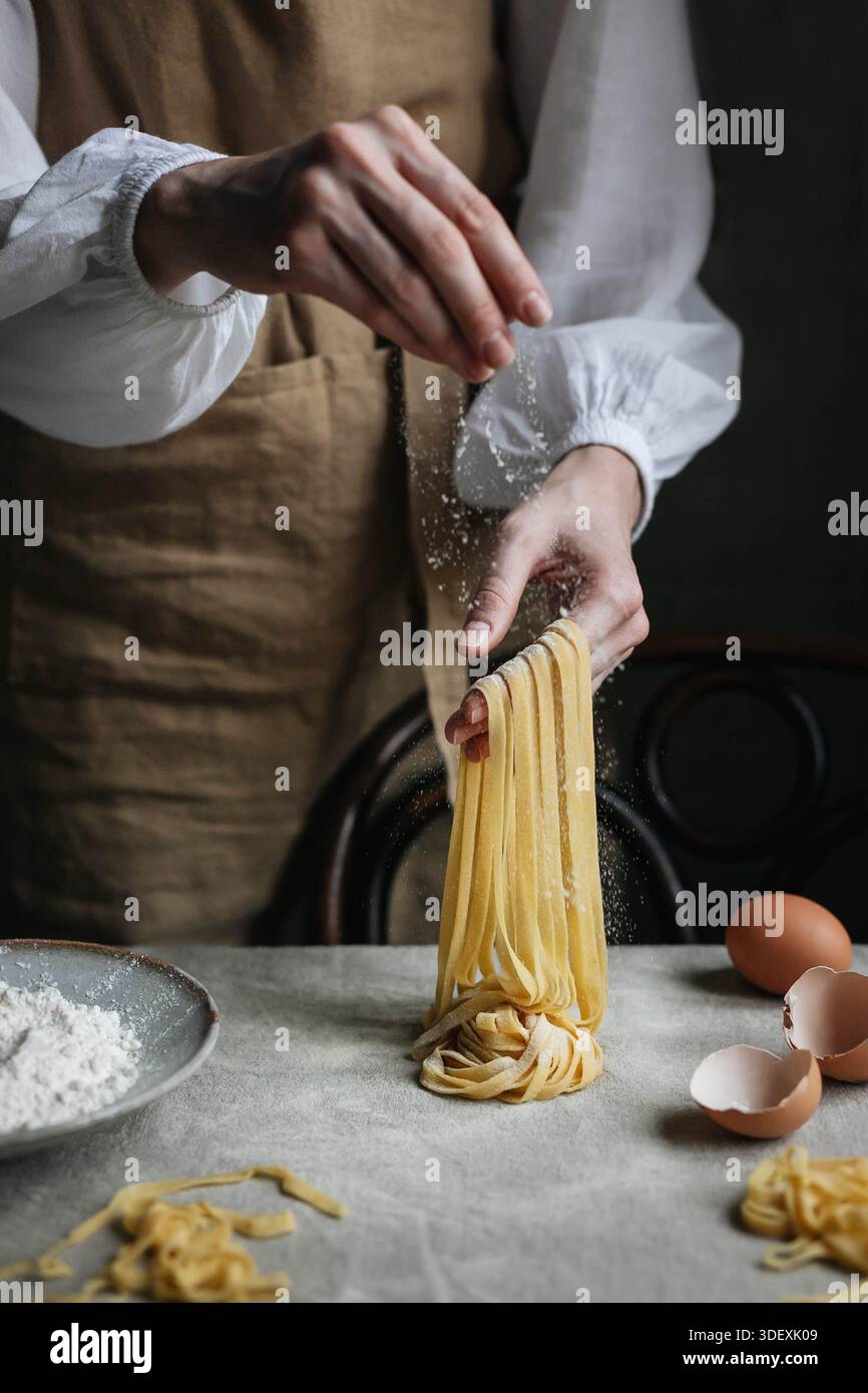 Homemade pasta making process. Rustic style. Hands in frame Stock Photo