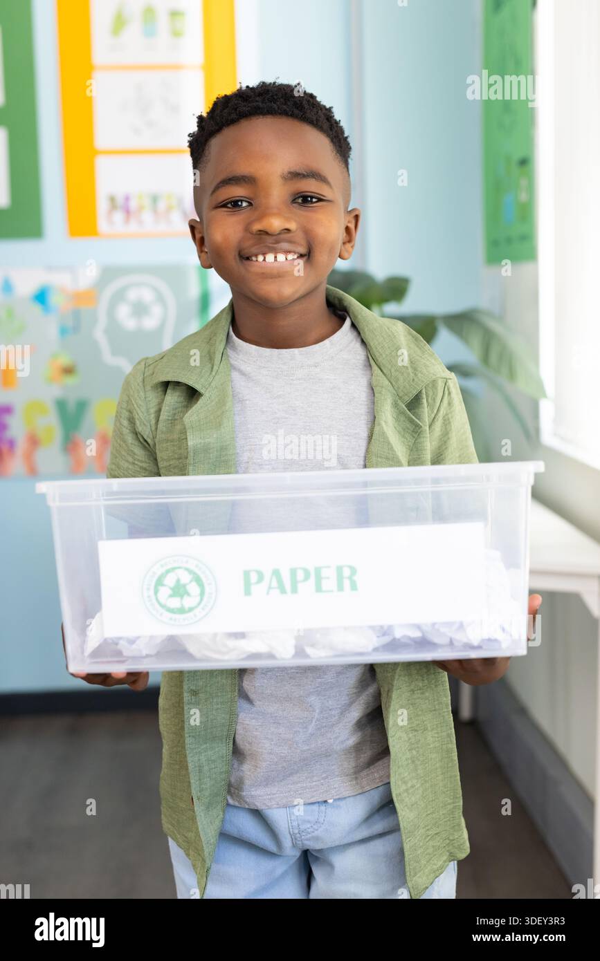 African American child smiling and holding clear plastic bin labeled ...