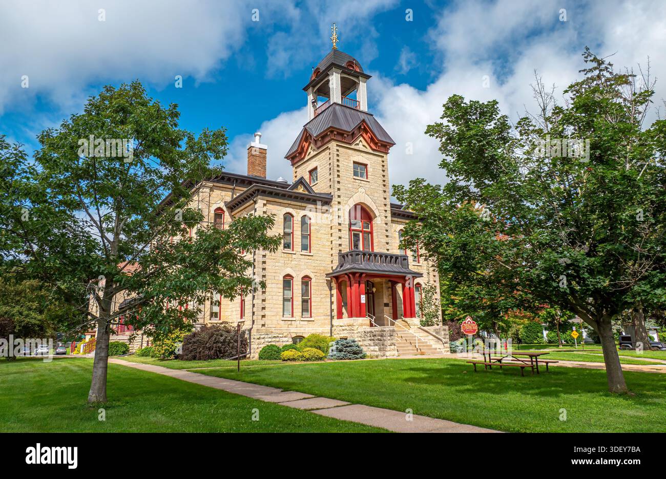 Vernon County Courthouse in Viroqua, Wisconsin, a historic limestone courthouse with a tower under a partly cloudy winter sky. Stock Photo