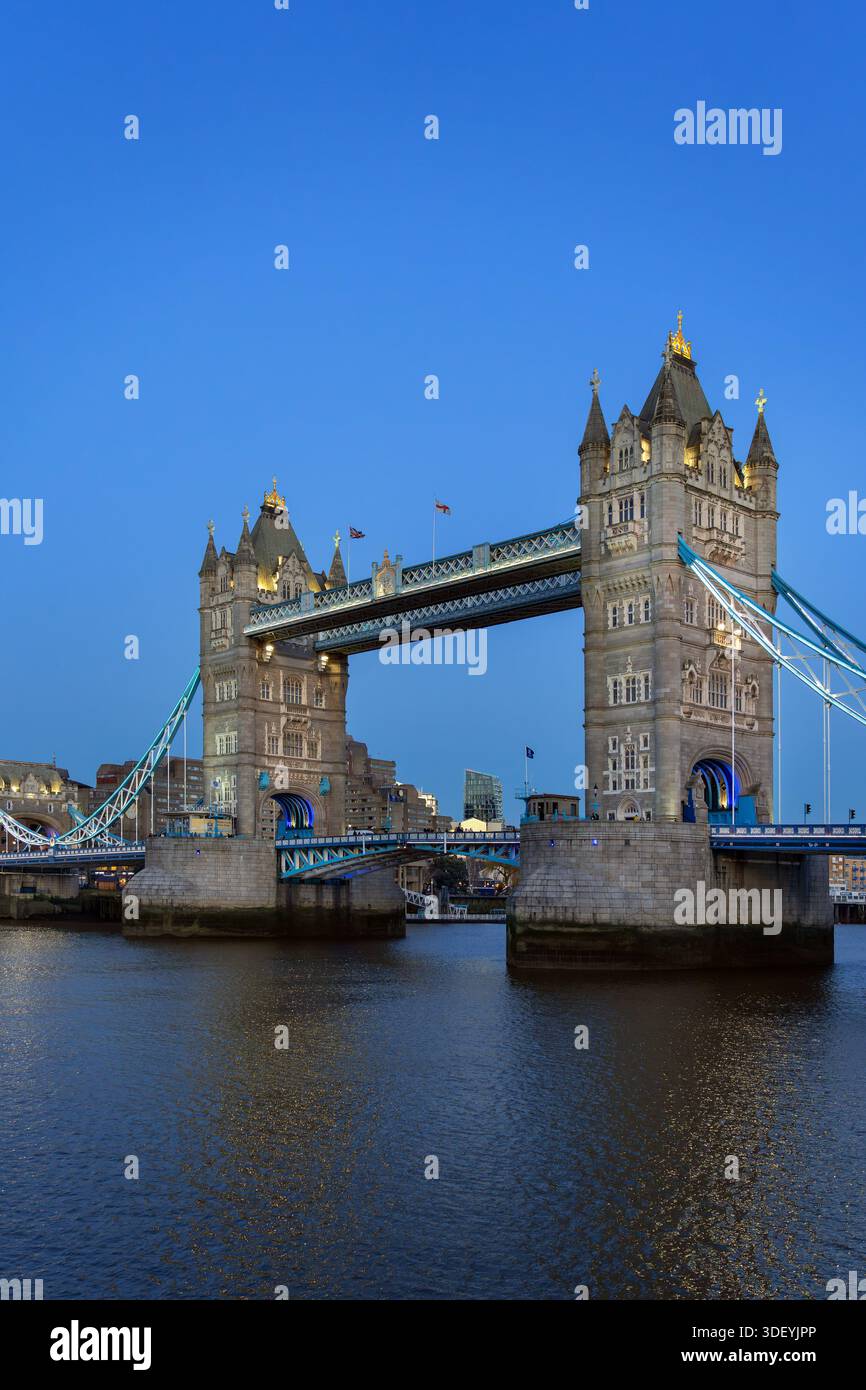 19th century Tower Bridge, neo-Gothic bascule / suspension bridge crossing the River Thames in the capital city London at dusk, England, UK Stock Photo