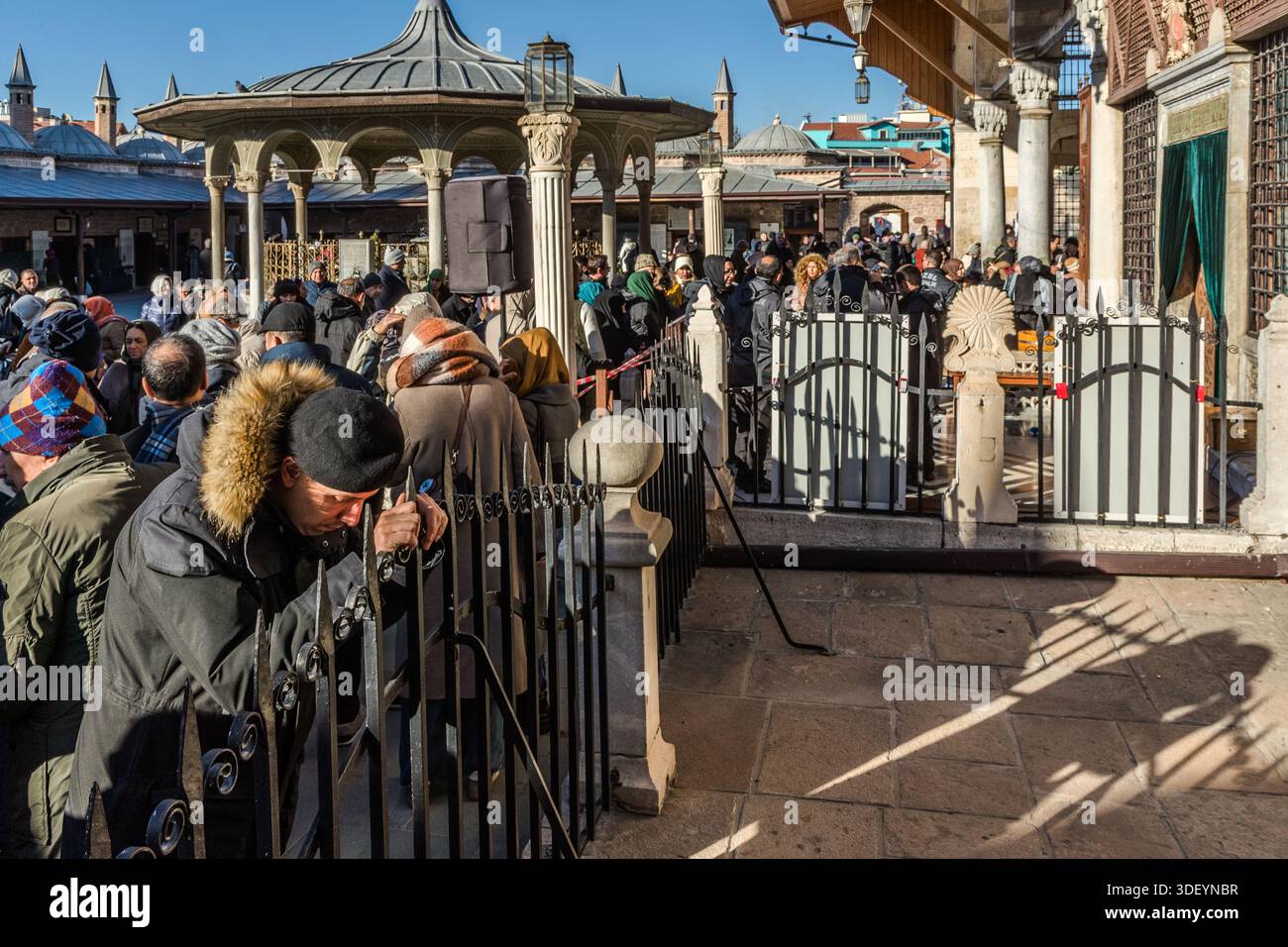The Mevlana Museum (Mevlânâ Müzesi) in Konya-Karatay, Turkey, attracts a large crowd in front of one of its gates. The museum is the mausoleum of the Sufi mystic Rumi (Jalāl ad-Dīn ar-Rūmī, 1207–1273), with an adjoining mosque and a former dervish cell; the turquoise dome above his tomb, dating from 1274, is regarded as a landmark of Konya. 17 December, the anniversary of Rumi’s death, is also the day of the annual Şeb-i Arus festival, when many pilgrims visit the mausoleum. Stock Photo
