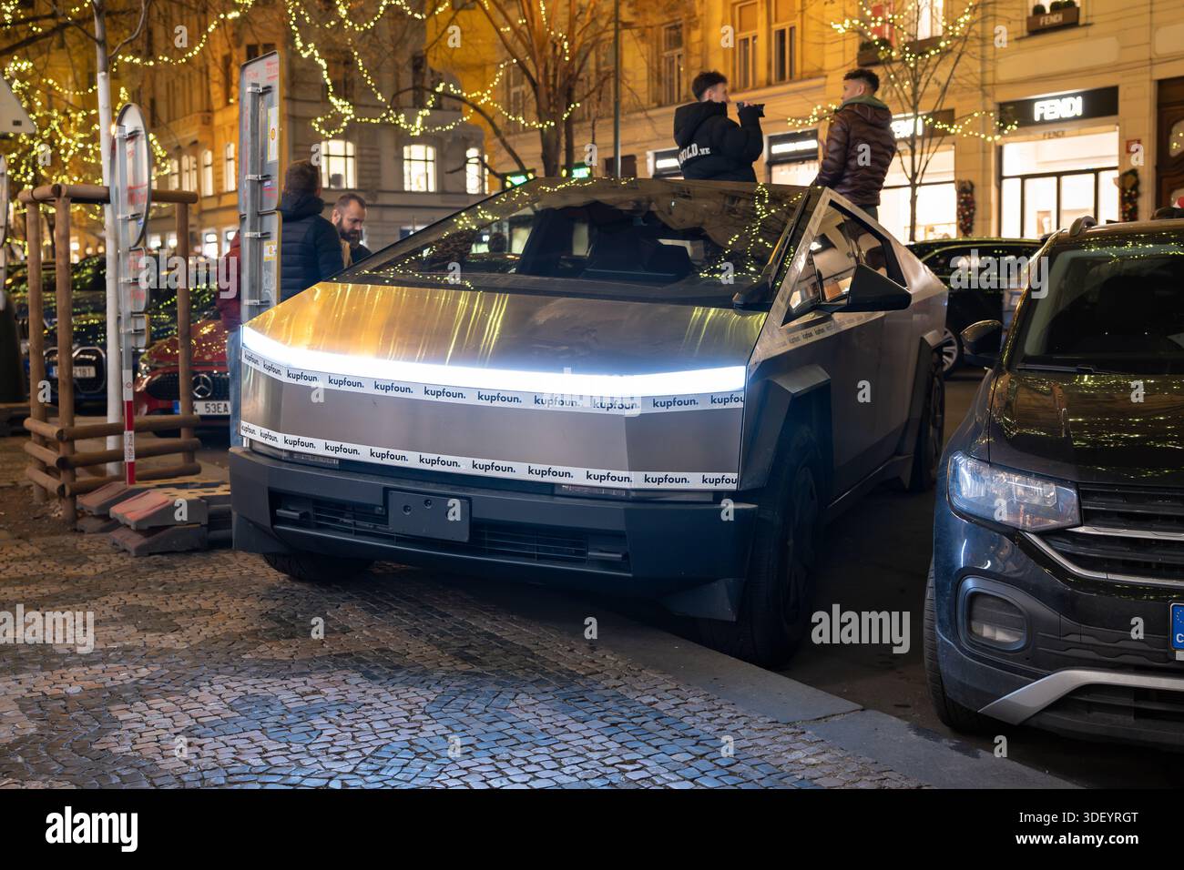Tesla Cybertruck in the prestigious boulevard Pařížská in Prague. BEV pickup truck in the polarizing design with the stainless steel exterior. Stock Photo