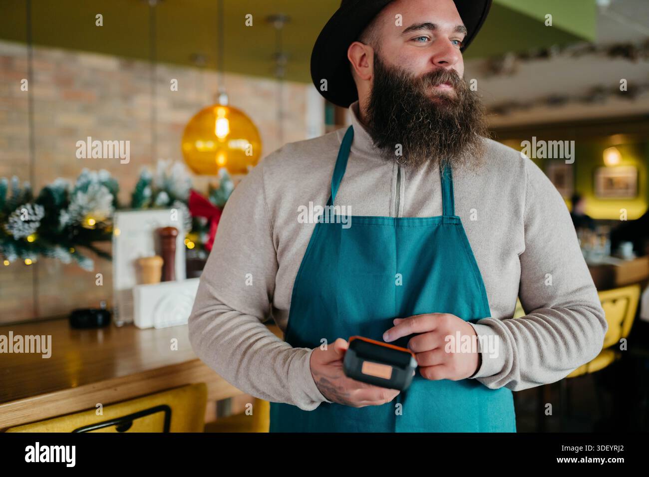 Smiling waiter taking payment from customer Stock Photo