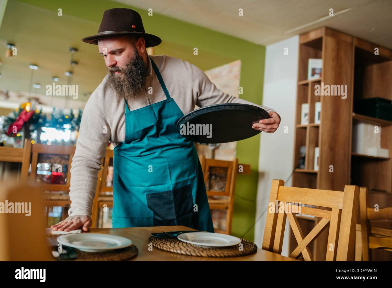 Happy Barista Using Mobile Phone in a Cafe Stock Photo