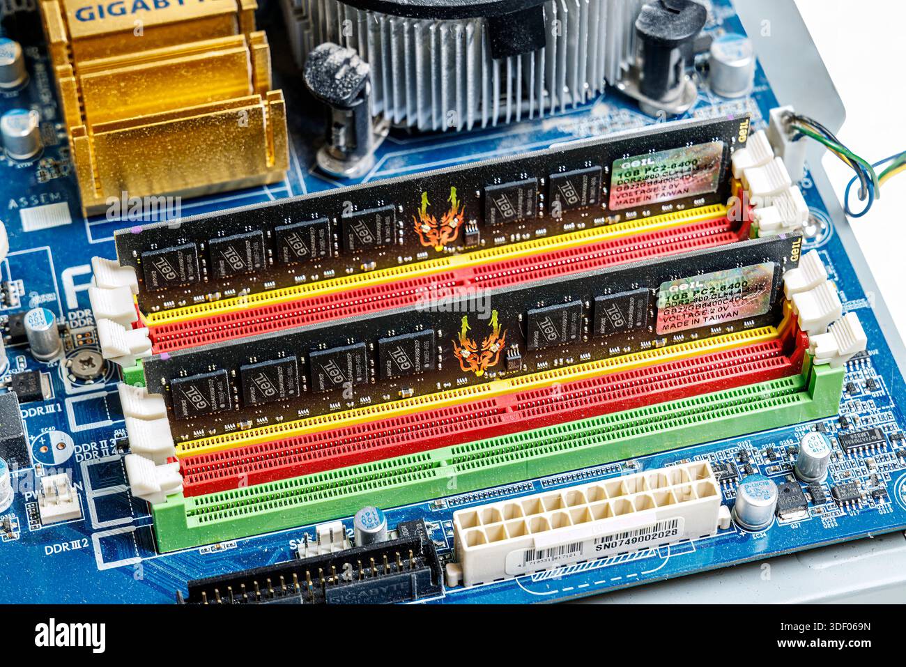 Computer main circuit board showing memory slots with RAM Stock Photo