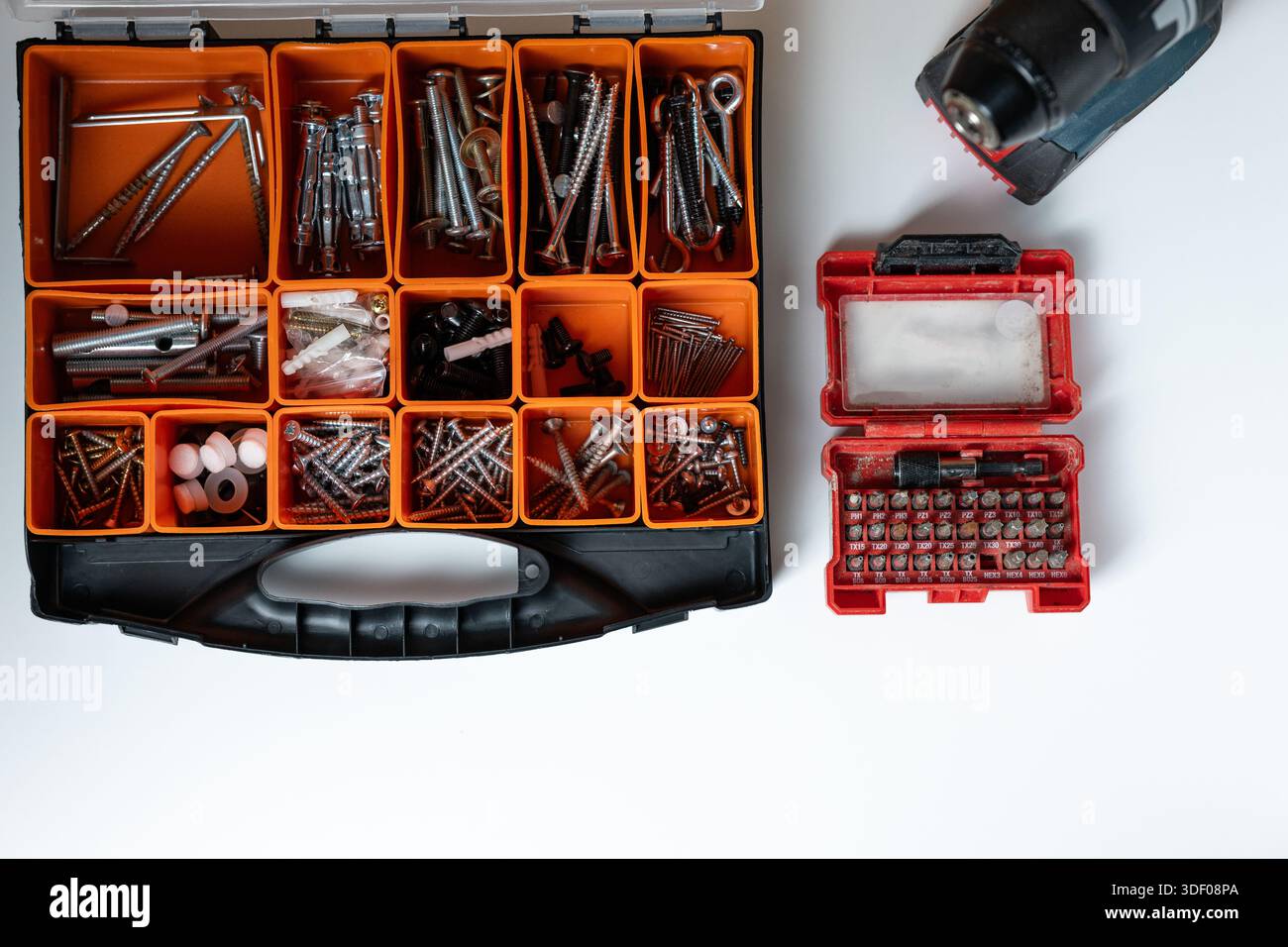 Top view of a toolbox with assorted screws, nails, and drill bits. Stock Photo