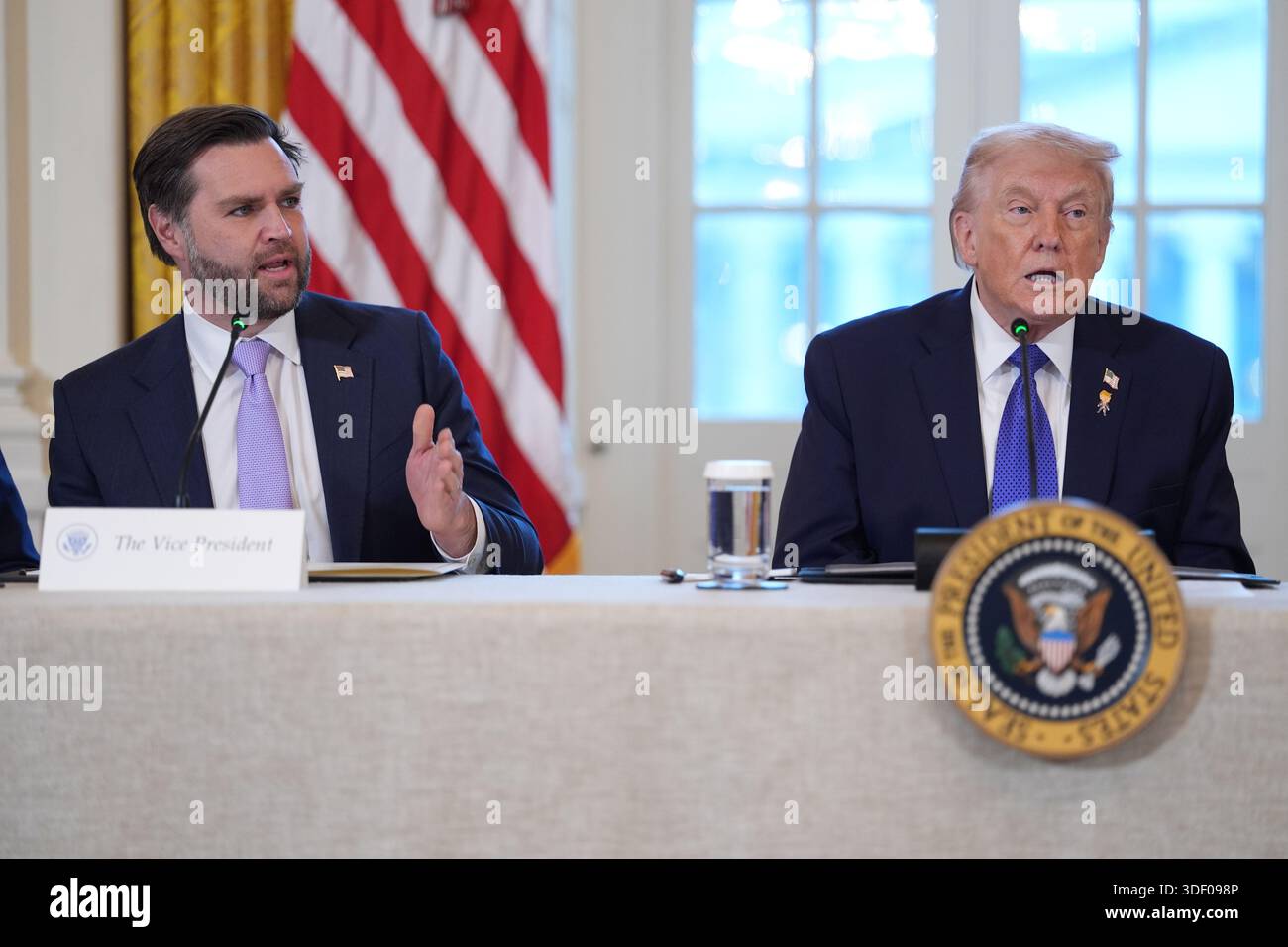 Vice President JD Vance speaks as President Donald Trump listens during ...