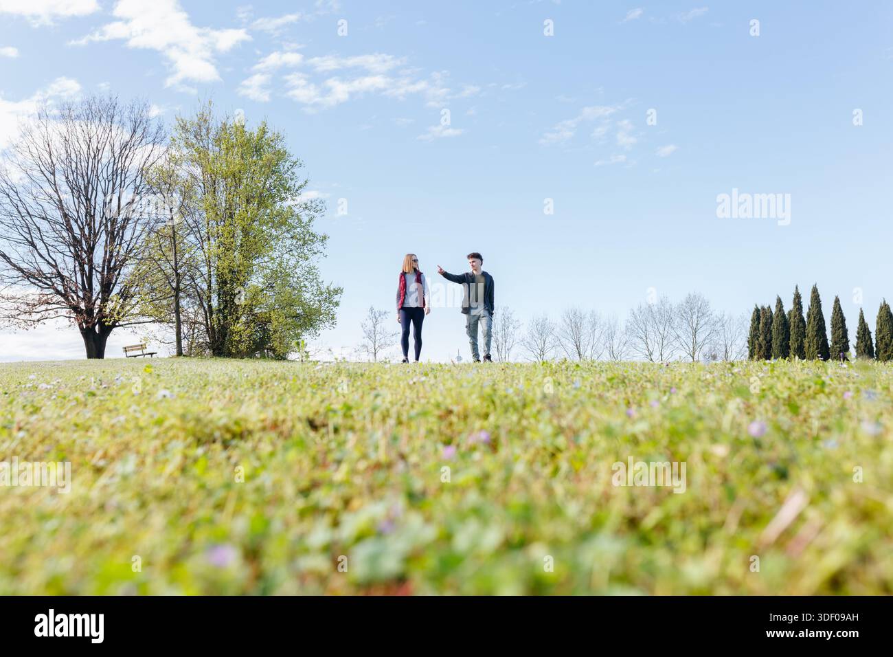 Two young people in a park talking hi-res stock photography and images ...