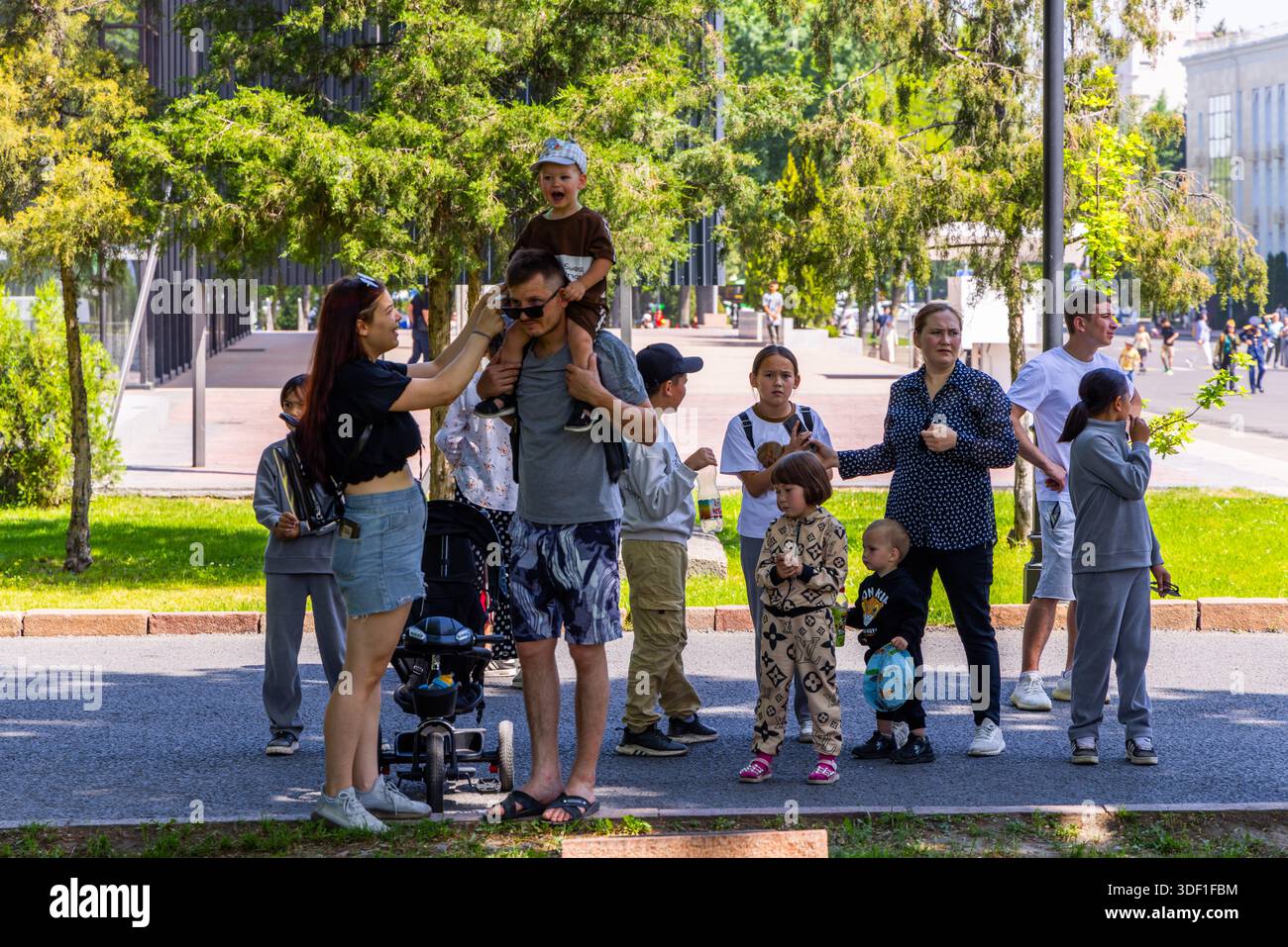 Diverse group of people enjoys a sunny summer day at the park after ...