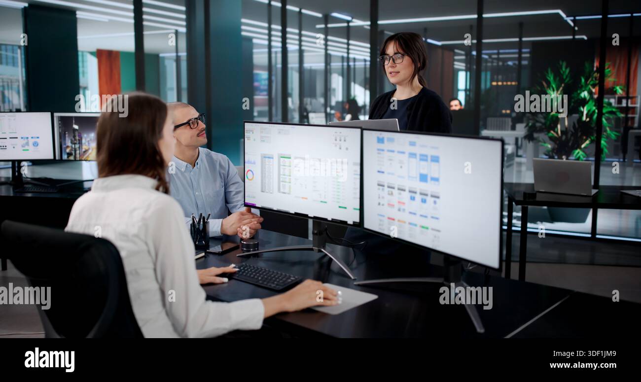 Creative Team Developing User Interfaces For Online App On Computer Stock Photo