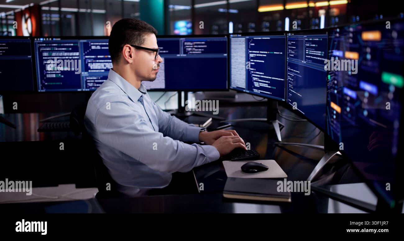 Latin Engineer Developing Code On Desktop In Modern Office Environment Stock Photo