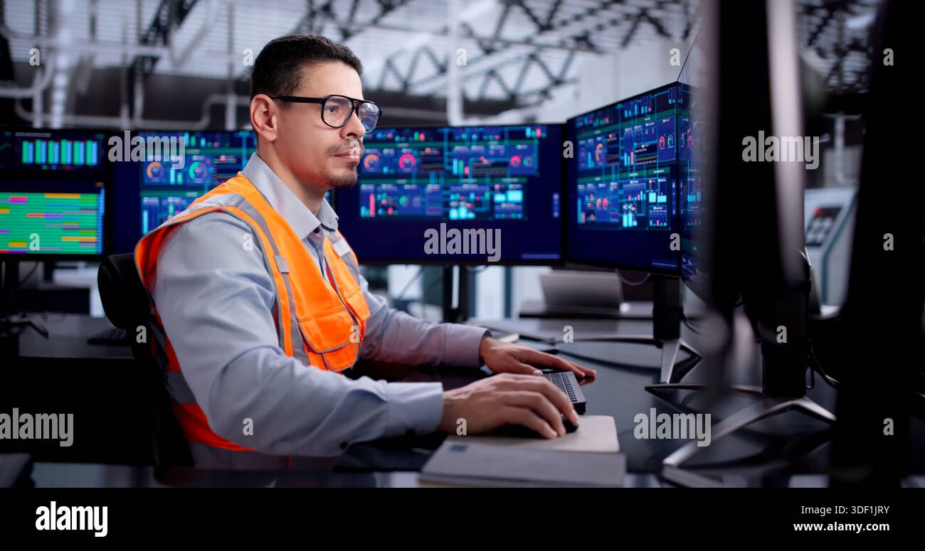 Efficient Engineer Operating SCADA System In Industrial Power Plant. Stock Photo