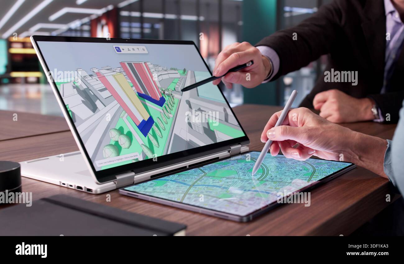 Multicultural Engineer And Real Estate Professional Inspecting GIS Mapping Stock Photo