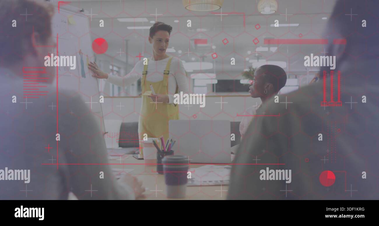 Presenter Using Yellow Note Gesturing presenter in yellow overalls presenting plan in office with ...