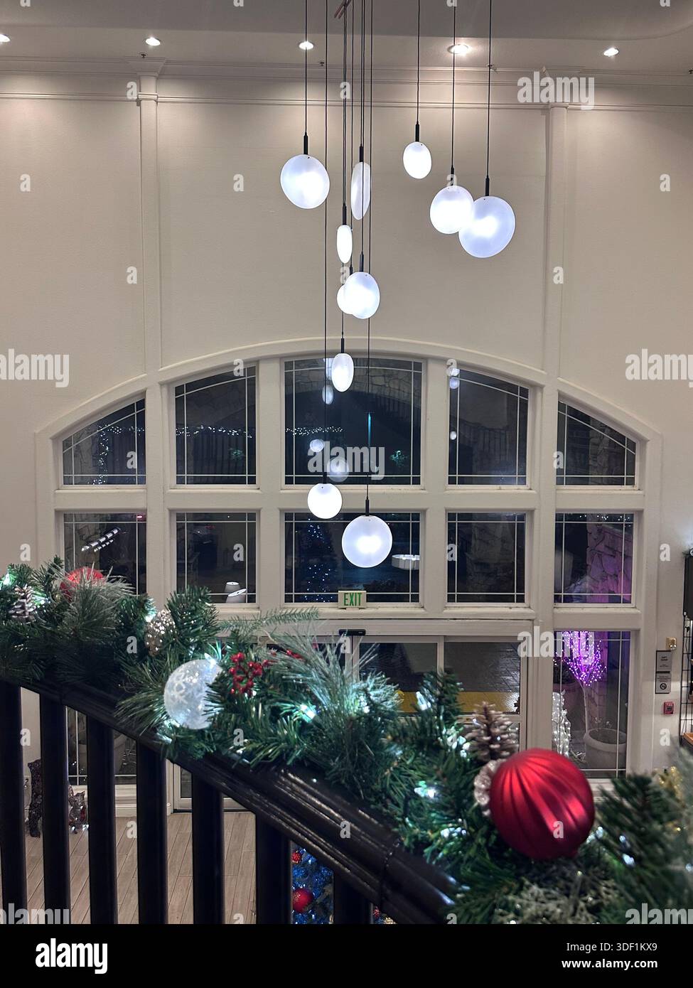 Luxury Hotel Lobby with Pendant Lighting and Festive Garland - Smartphone Captured Stock Image