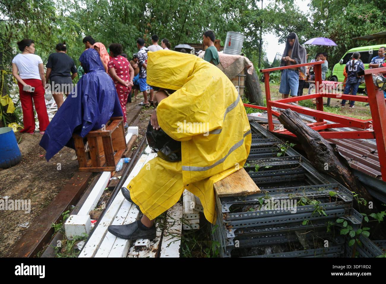 Family members and relatives wait as rescuers continue operations on a ...