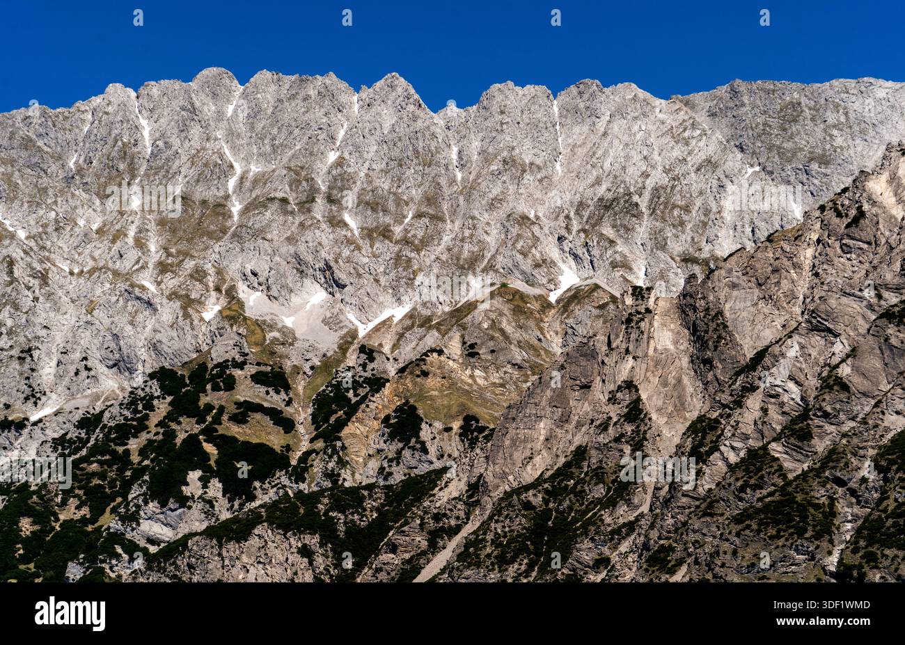 Rugged mountain peaks under a clear blue sky. Stock Photo