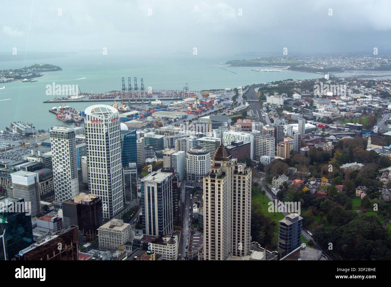 Aerial view of a coastal city with modern skyscrapers, a busy harbor ...