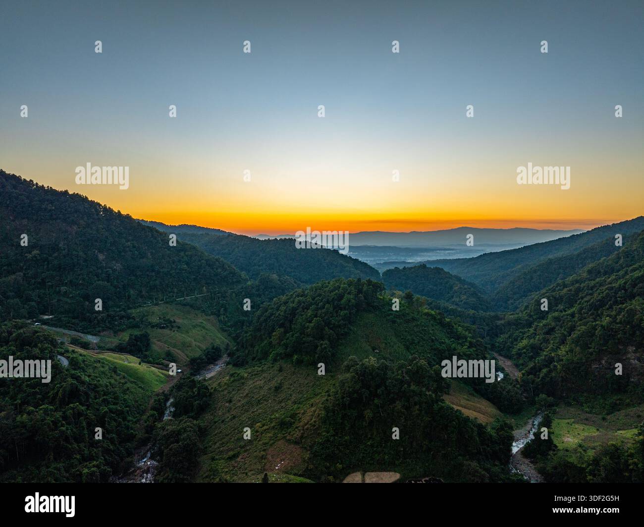 An aerial view reveals layered mountain ranges stretching to the ...