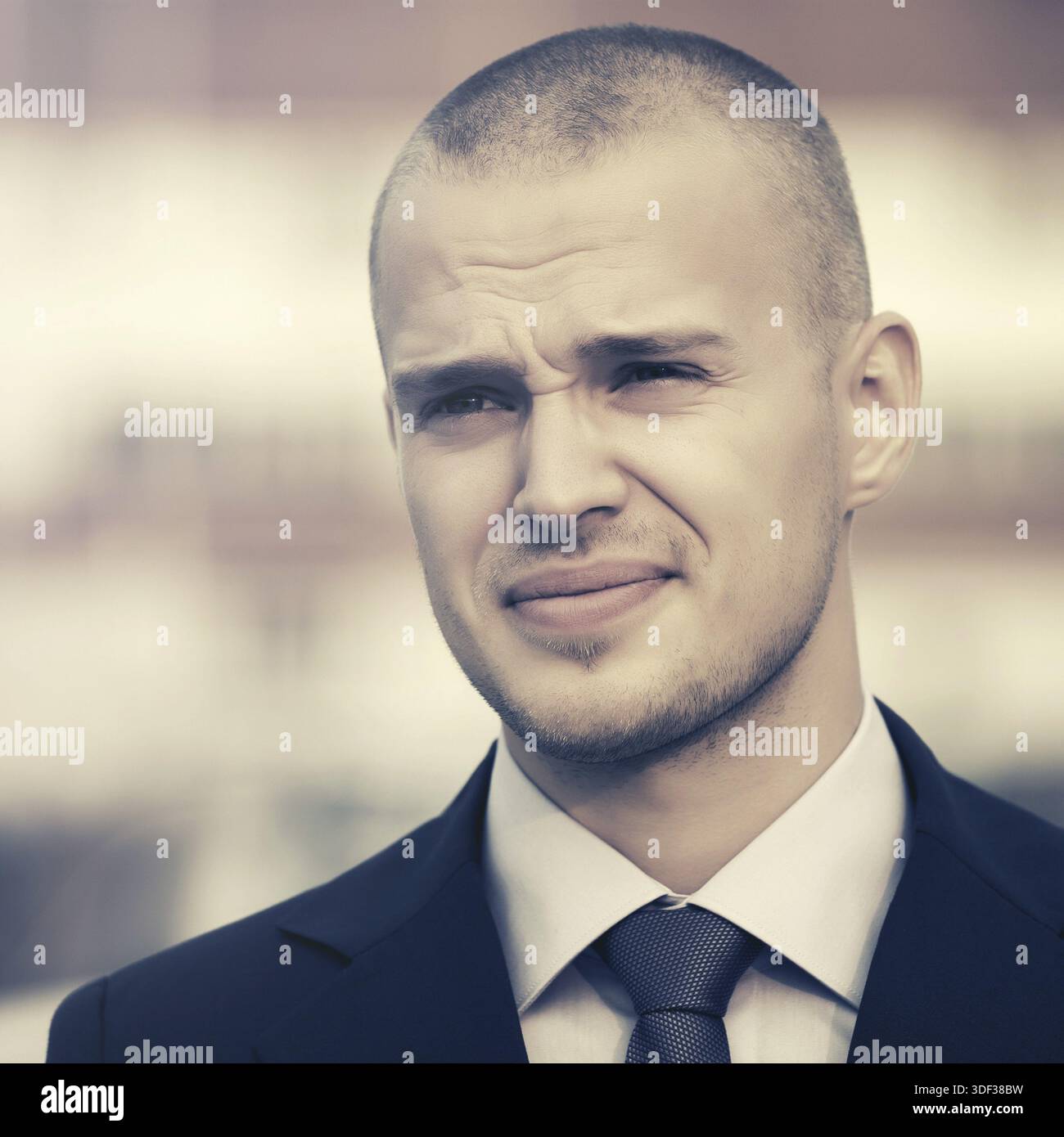 Young handsome businessman in dark blue suit jacket walking in city street Stock Photo