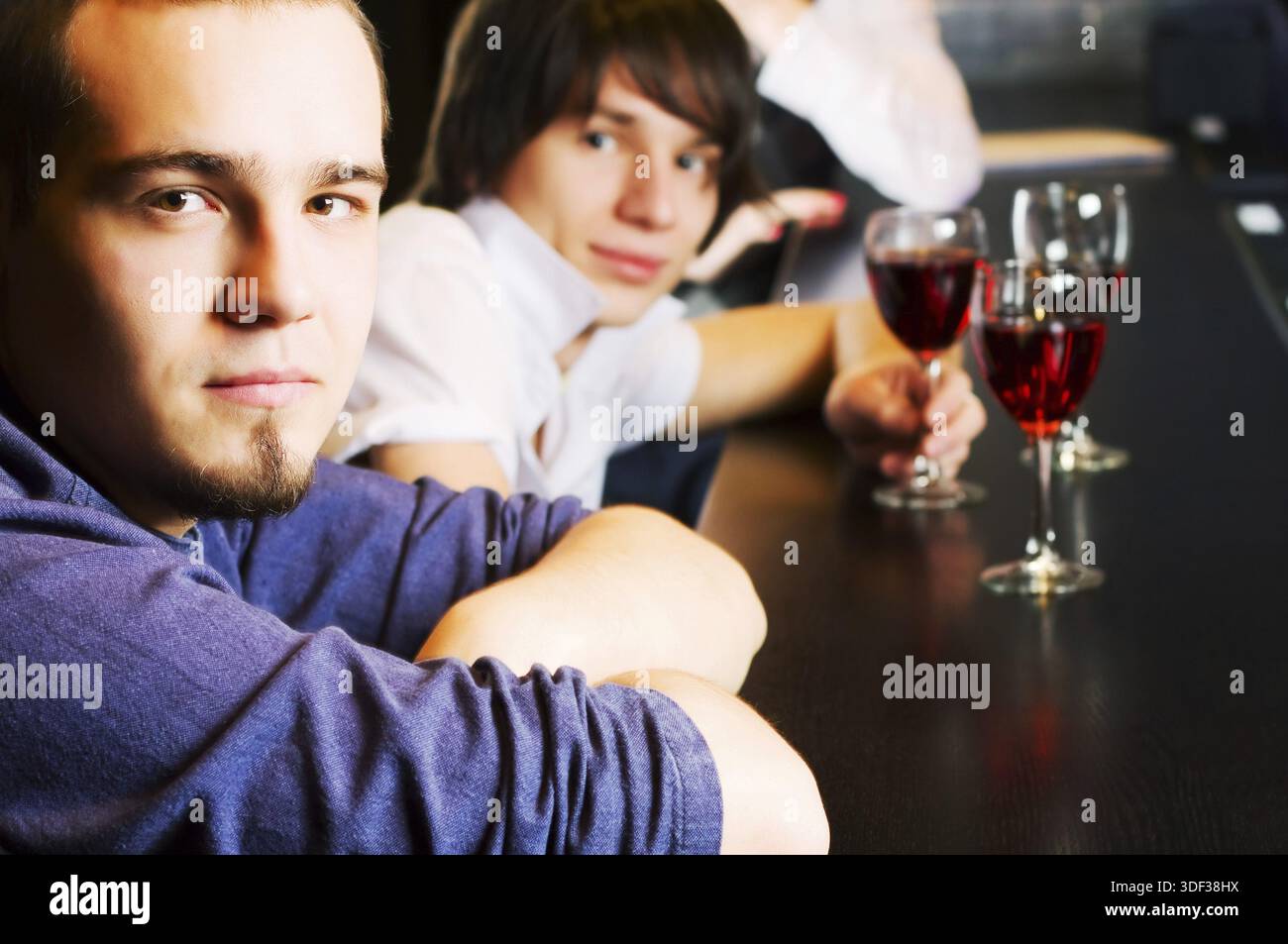 Young men relaxing at a bar counter Stock Photo