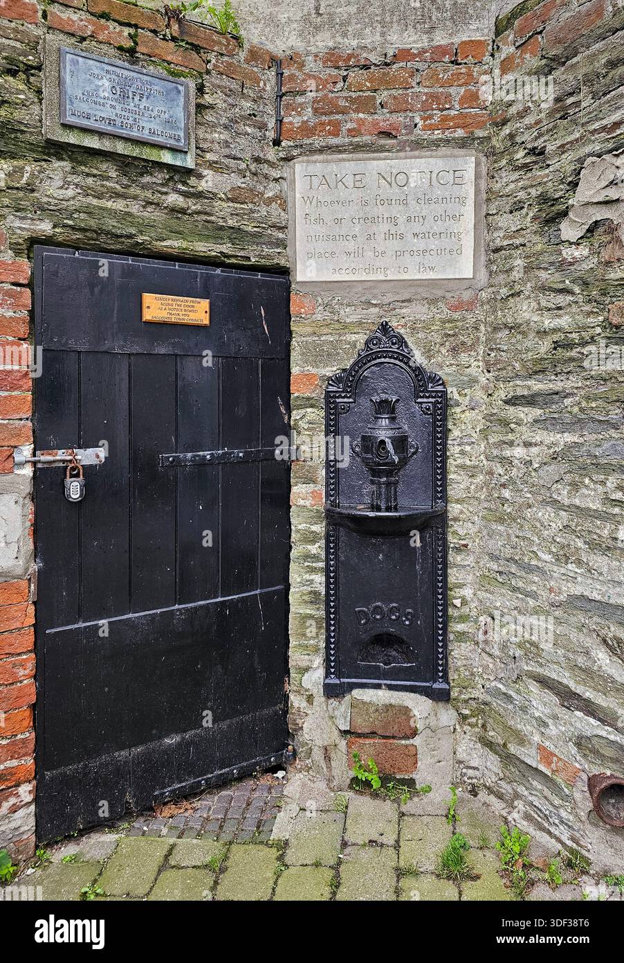 Salcombe town water pump.  There is a bowl built in for drinking water for dogs. Note that an unsightly modern notice has been removed from the image. - Smartphone Captured Stock Image