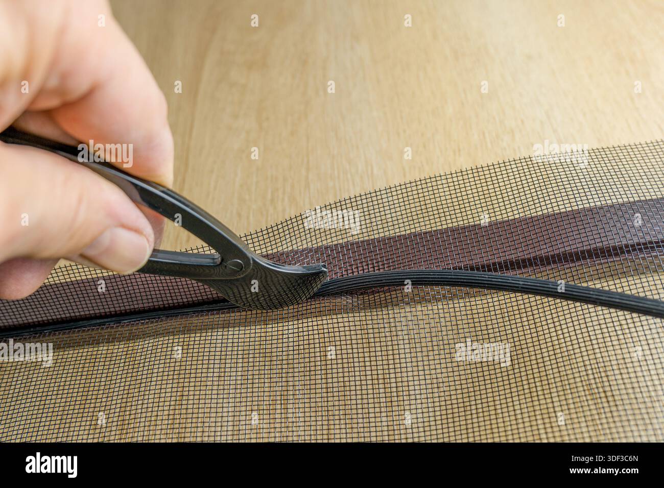 Installing the net into the window aluminium frame or door Stock Photo