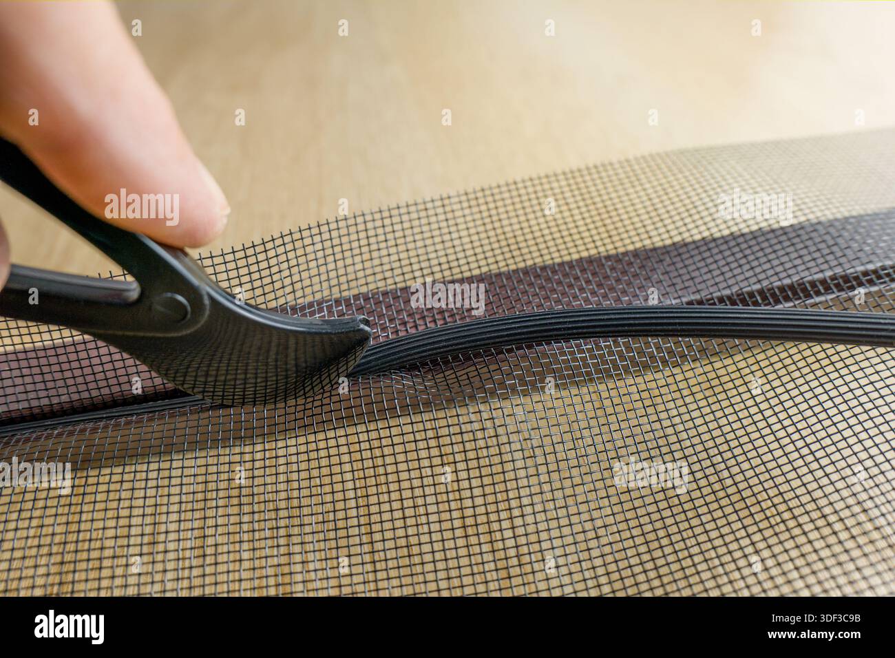 Installing the net into the window aluminium frame or door Stock Photo