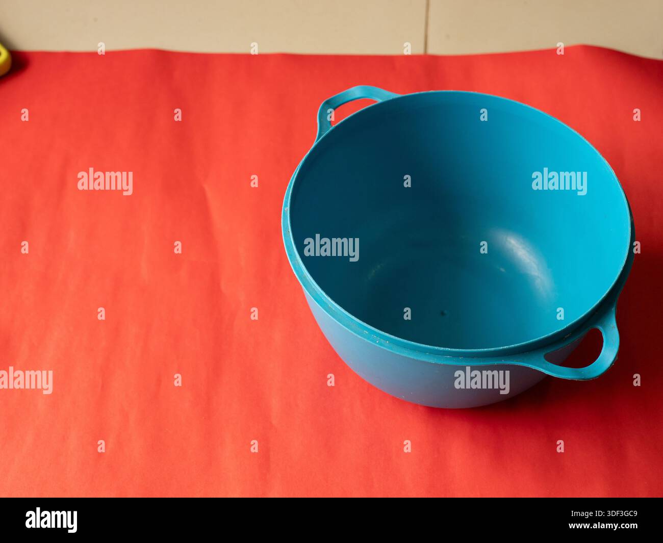Empty blue bowl on a red background, presented as a bold color-contrast kitchenware mockup with copy space. Stock Photo