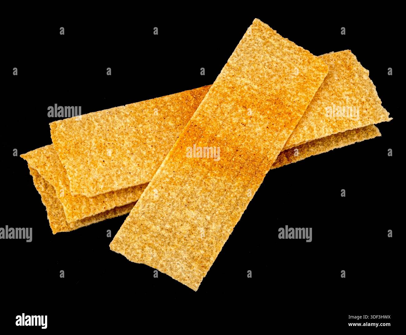 Long chips isolated on black background, rectangular mashed potato snacks, package design element Stock Photo