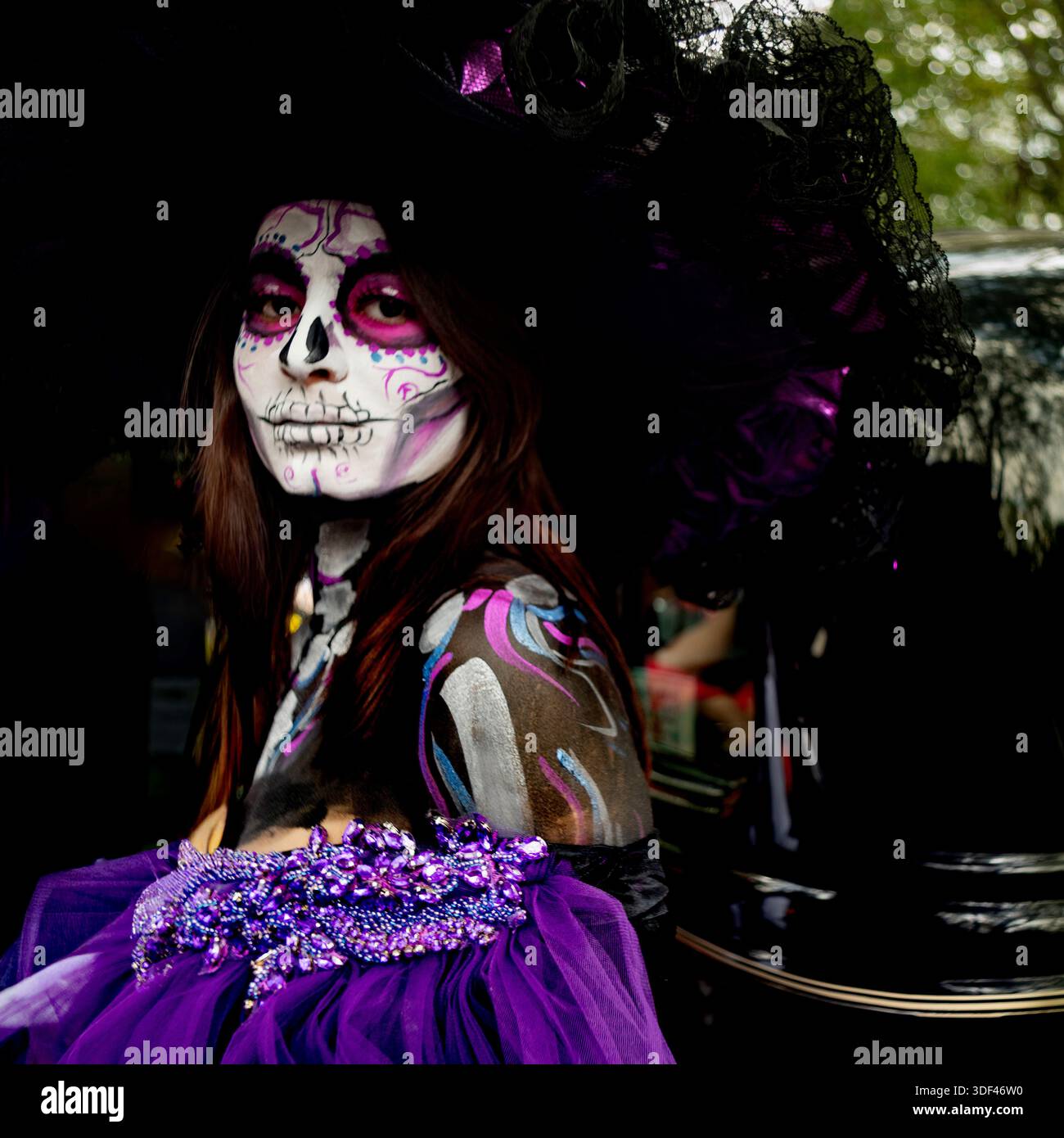 Portrait of a woman wearing skull makeup and a costume during the Day of the Dead parade in Mexico City, Mexico. Stock Photo