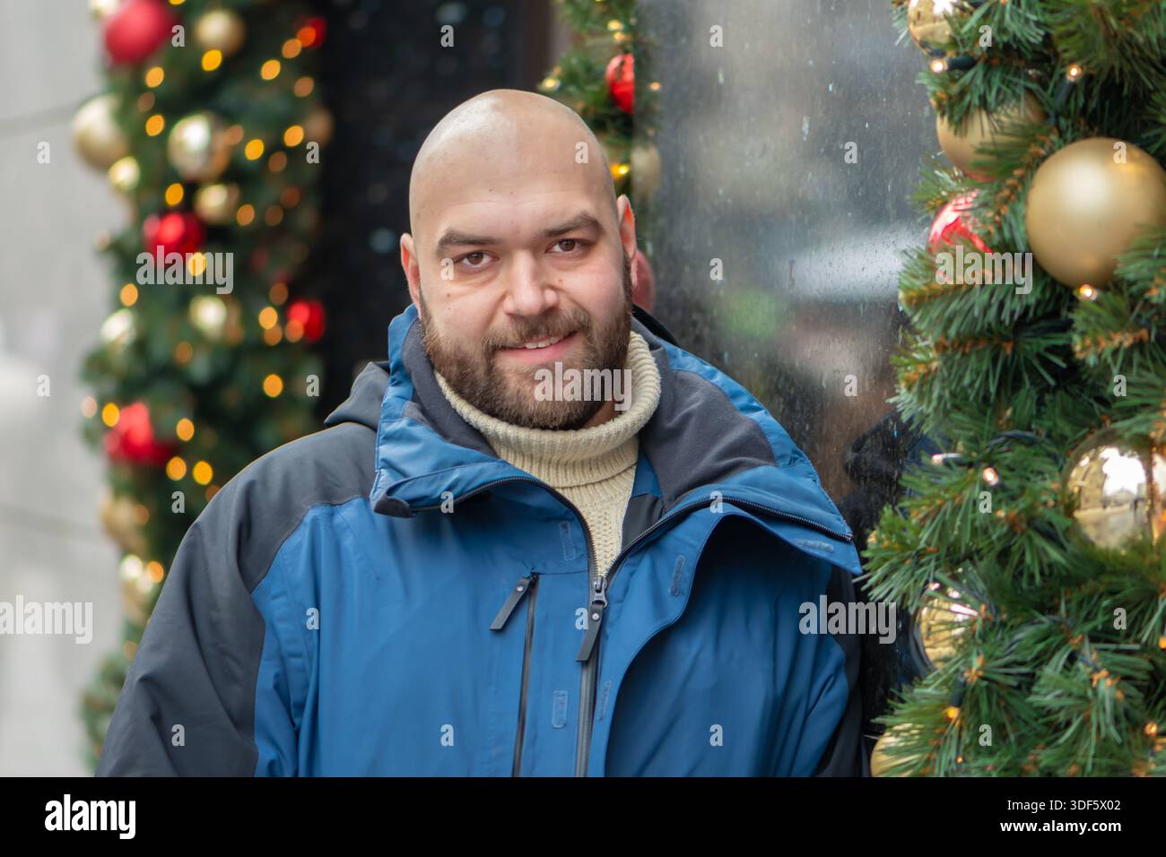 A smiling middle-aged man next to the festive decor Stock Photo