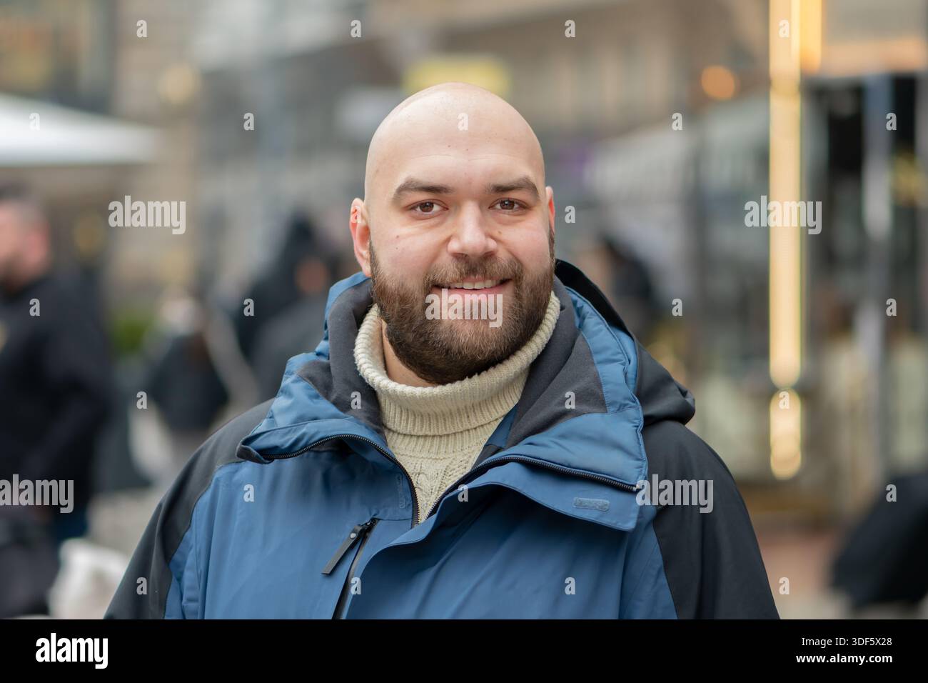 Portrait of a bald man 35 years old on a city street in winter