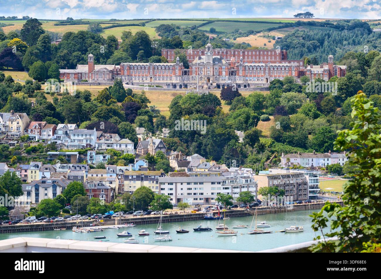 View of the Britannia Royal Naval College (BRNC Dartmouth) sitting proudly in tree-clad hills overlooking the River Dart, South Hams, Devon England UK Stock Photo
