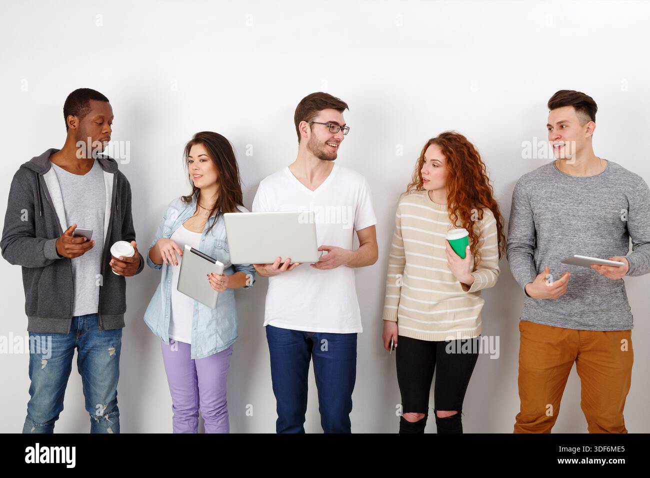 Young people using gadgets, students, technology Stock Photo