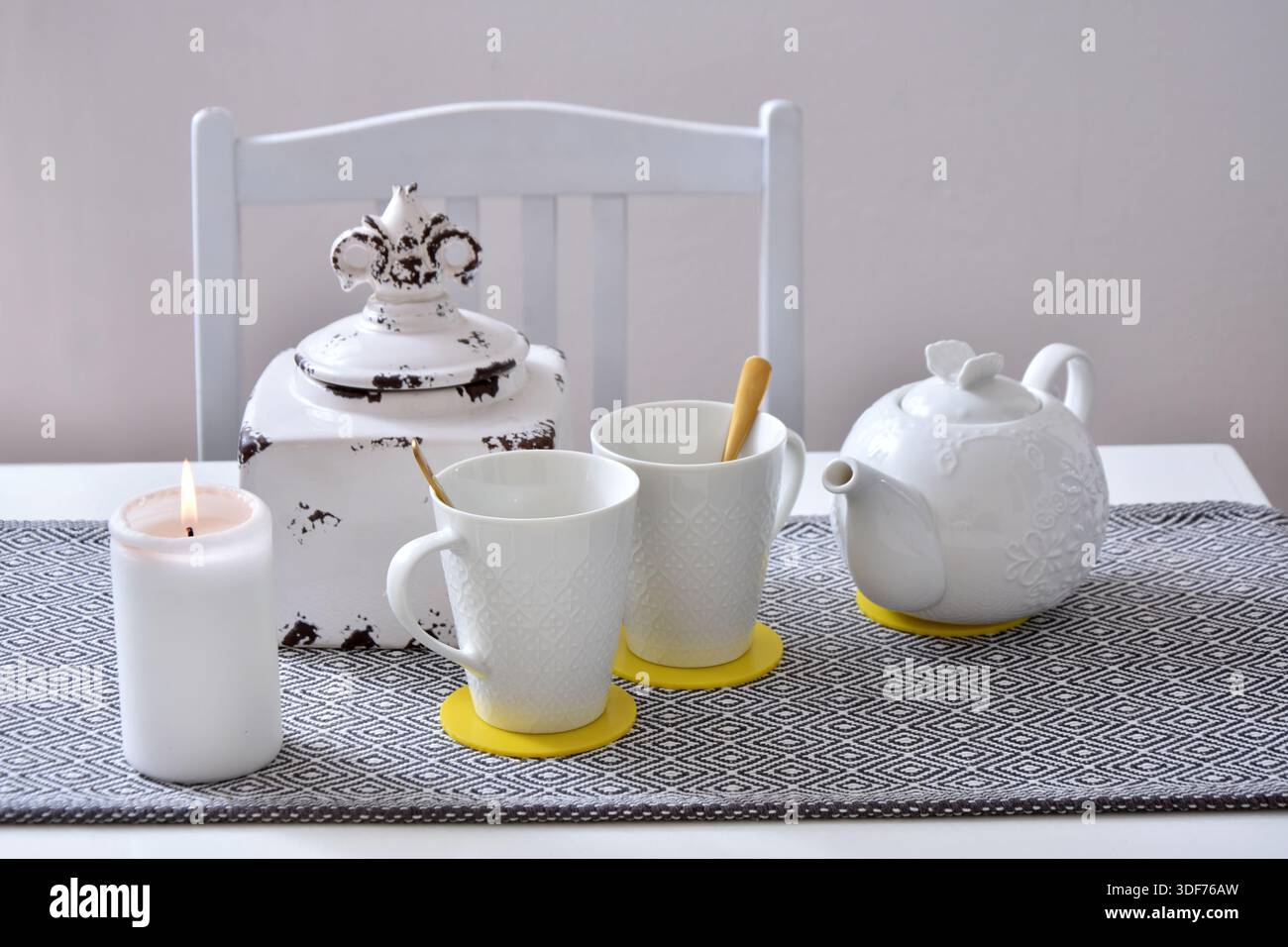 White ceramic tea set with two cups and a teapot on the table Stock Photo