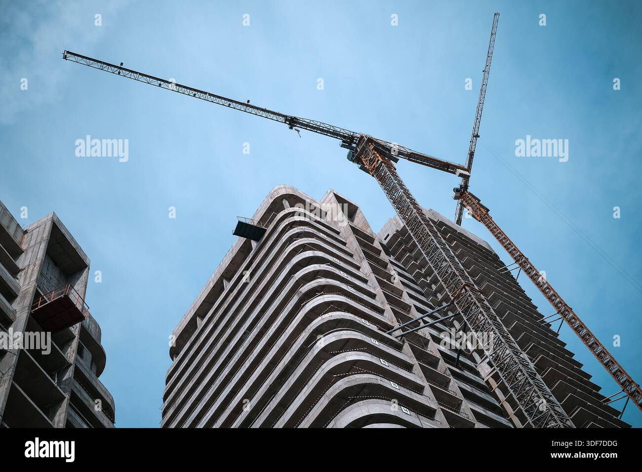 Tall modern building being built from concrete Stock Photo