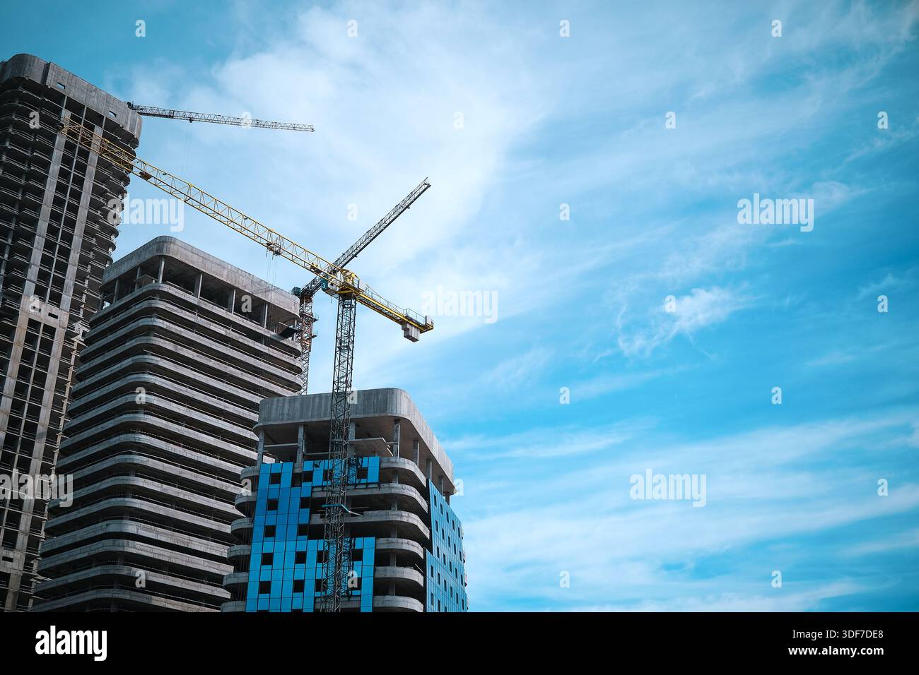 Tall modern building being built from concrete Stock Photo
