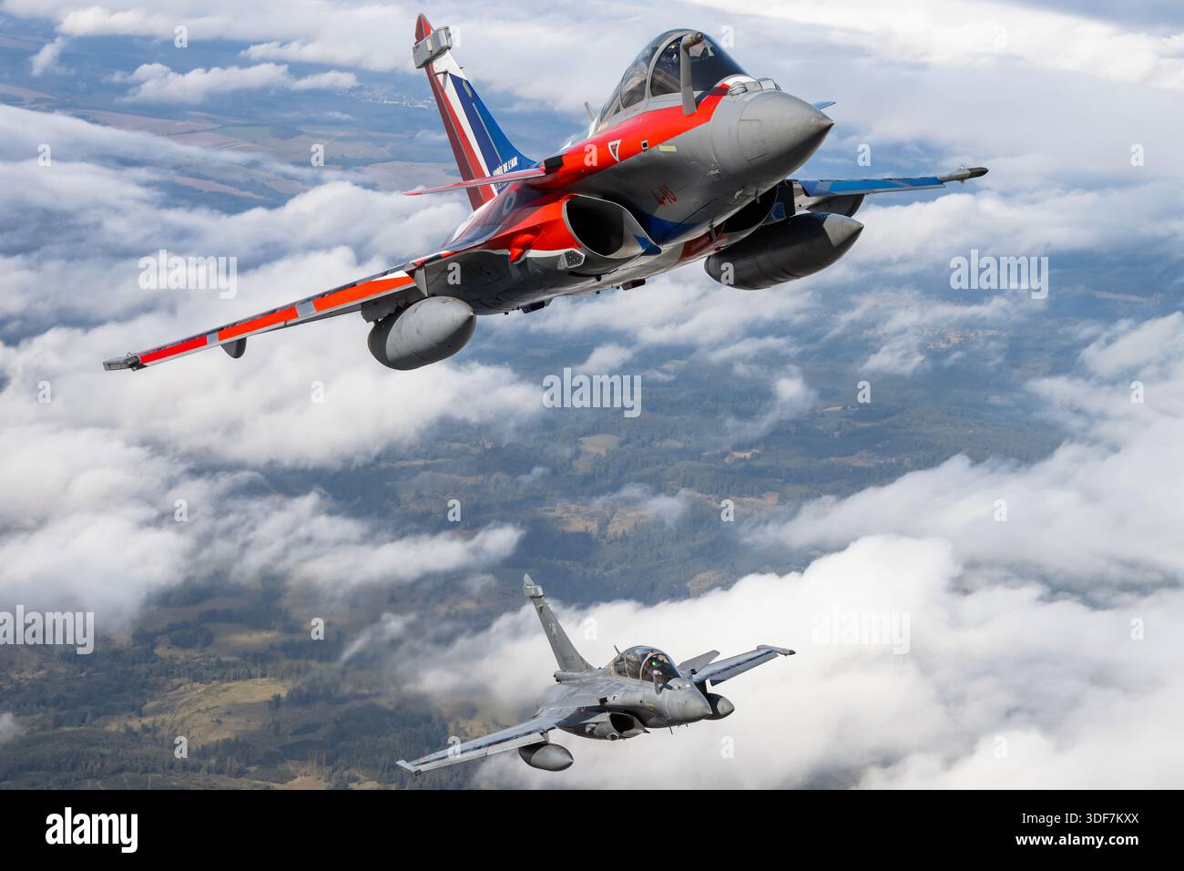 A pair of French Air Force Dassault Rafale aircraft fly in close ...