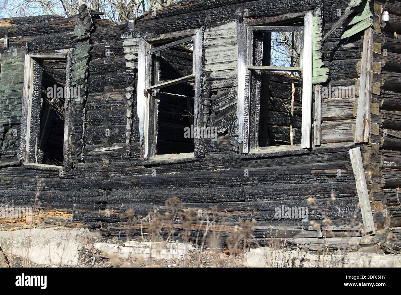 Empty window Burnt old wooden house Stock Photo