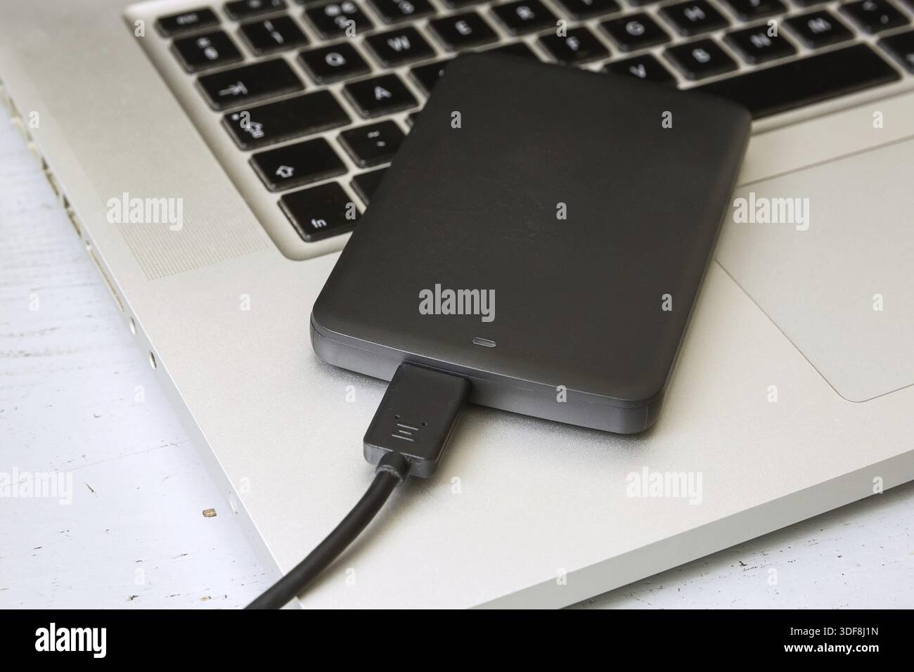 External Hard Disk Over Laptop Keyboard Stock Photo