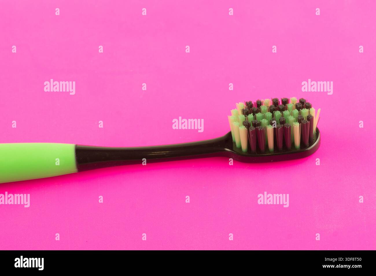 new modern toothbrush isolated on pink solid background Stock Photo