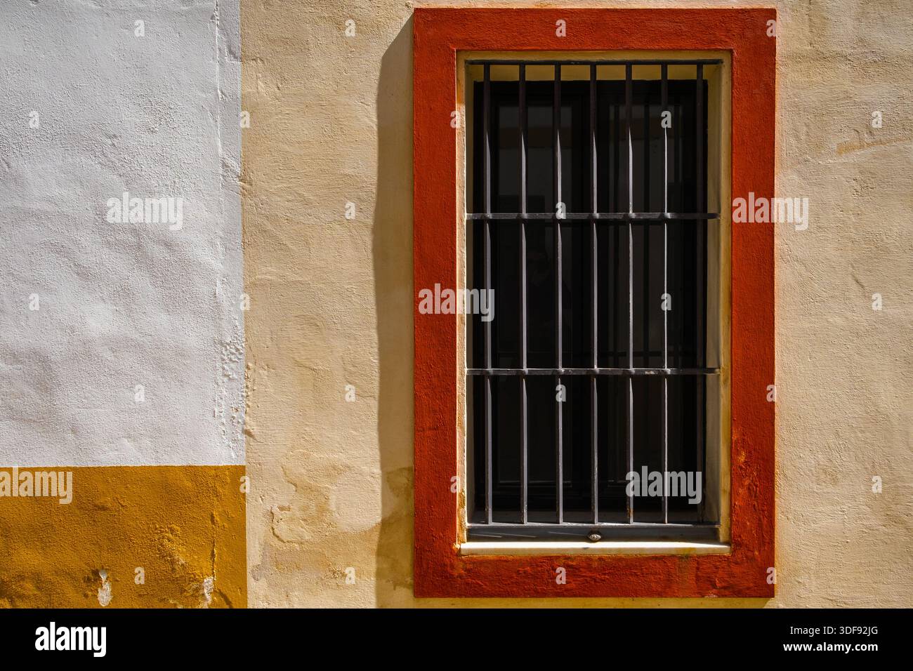 Window with iron bars and painted frame Stock Photo