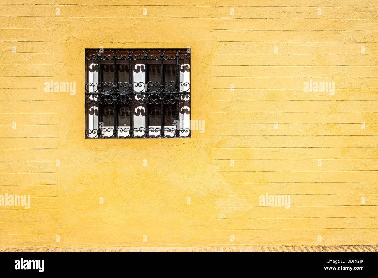 Window with iron bars and painted frame Stock Photo