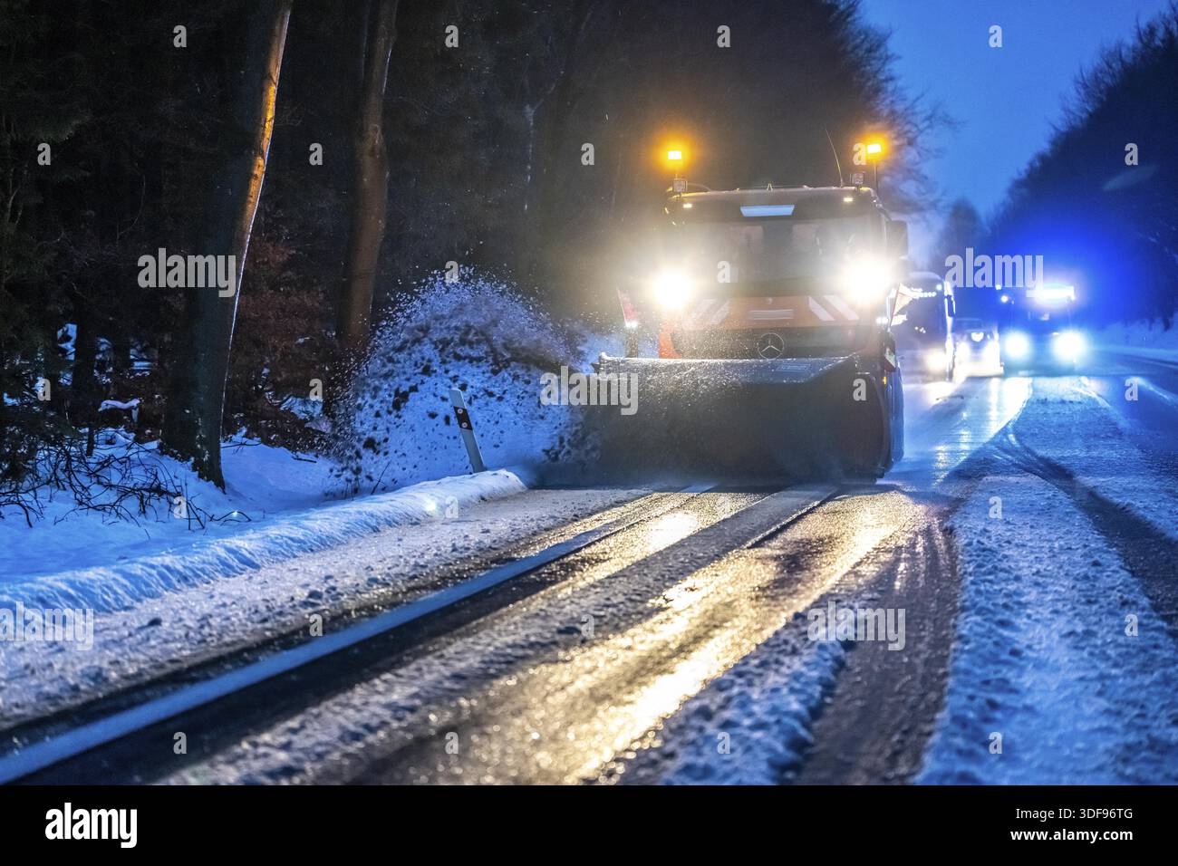 Winter service, spreader and snow plough in use, clears snow and slush from a regional road, Bergisches Land, near Marienheide, North Rhine-Westphalia Stock Photo